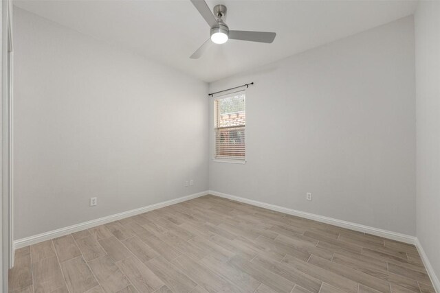 empty room featuring light wood-style floors, baseboards, and ceiling fan
