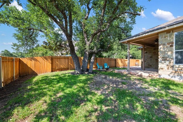 view of yard featuring a ceiling fan and a patio