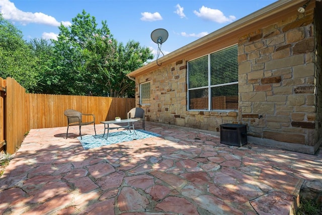 view of patio featuring fence and central AC unit