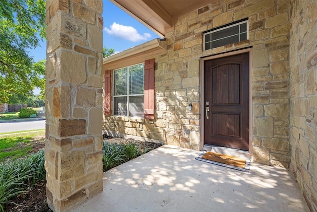 property entrance featuring stone siding