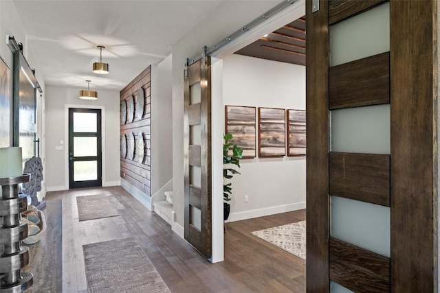 217 Northcrest Dr, Liberty Hill, TX 78642 - entrance foyer featuring a barn door, dark wood-style floors, baseboards, and stairs