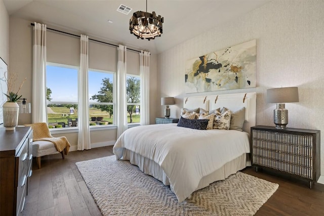 217 Northcrest Dr, Liberty Hill, TX 78642 - bedroom with a chandelier, dark wood finished floors, and baseboards