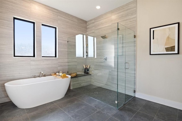 217 Northcrest Dr, Liberty Hill, TX 78642 - full bath featuring a freestanding tub, a shower stall, baseboards, and tile walls