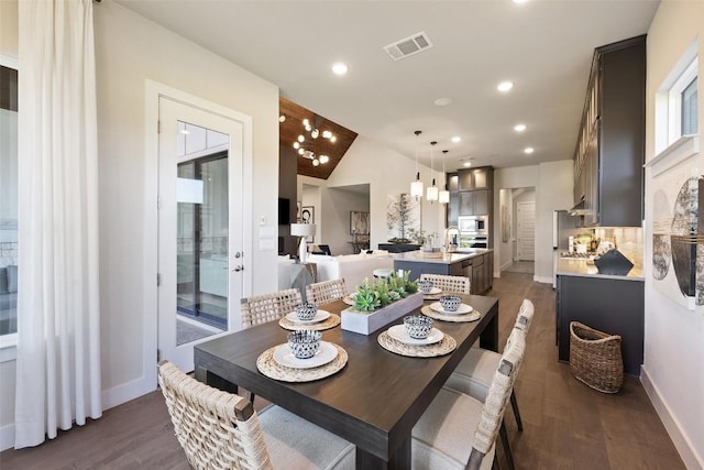 217 Northcrest Dr, Liberty Hill, TX 78642 - dining area with dark wood finished floors, baseboards, recessed lighting, and vaulted ceiling