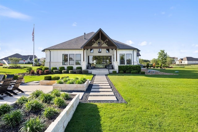 217 Northcrest Dr, Liberty Hill, TX 78642 - rear view of house with a lawn, board and batten siding, and roof with shingles
