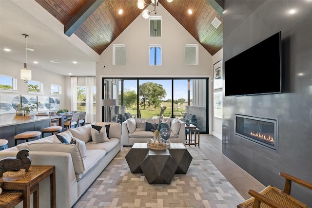 217 Northcrest Dr, Liberty Hill, TX 78642 - living room with wooden ceiling, a tiled fireplace, high vaulted ceiling, plenty of natural light, and recessed lighting