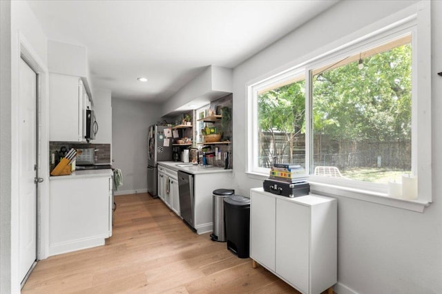 2312 Aldford Dr, Austin, TX 78745 - kitchen with stainless steel appliances, light countertops, healthy amount of natural light, light wood-style flooring, and recessed lighting