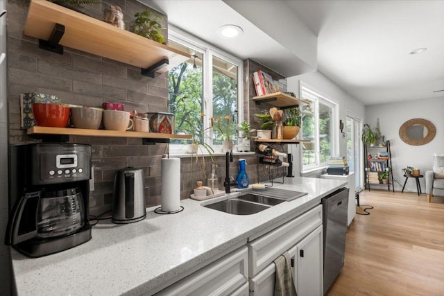 2312 Aldford Dr, Austin, TX 78745 - kitchen with open shelves, a sink, stainless steel dishwasher, backsplash, and healthy amount of natural light