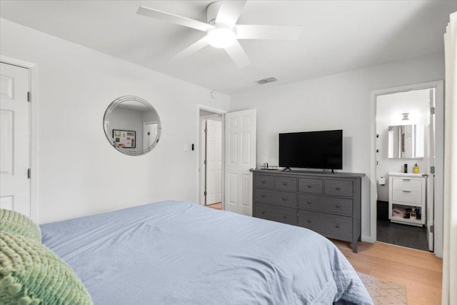 2312 Aldford Dr, Austin, TX 78745 - bedroom with light wood finished floors, a ceiling fan, and ensuite bath