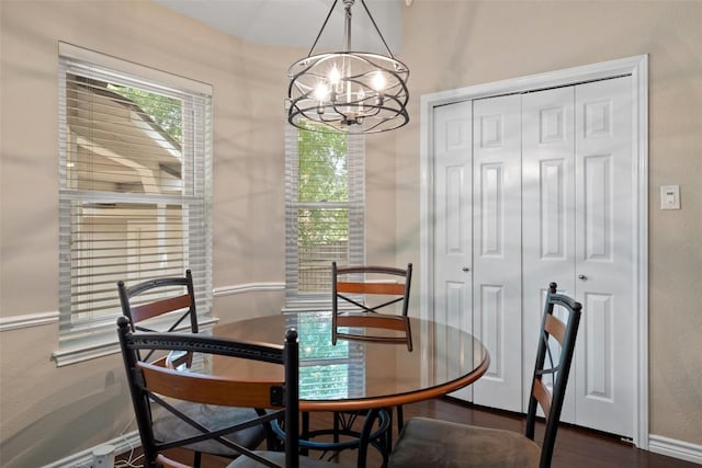 11008 Needham Ct, Austin, TX 78739 - dining space featuring a chandelier, healthy amount of natural light, and dark wood-style flooring
