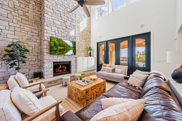 3500 River Oaks Dr, Kingsland, TX 78639 - living room with a towering ceiling, wood finished floors, ceiling fan, and a stone fireplace