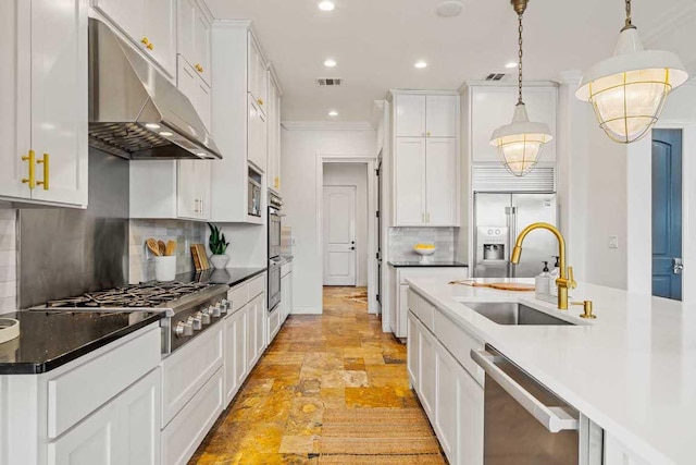 3500 River Oaks Dr, Kingsland, TX 78639 - kitchen with range hood, stainless steel appliances, light stone finish floors, white cabinets, and tasteful backsplash