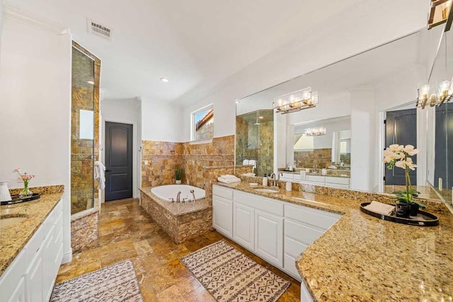 3500 River Oaks Dr, Kingsland, TX 78639 - bathroom featuring a chandelier, two vanities, a stall shower, and tile walls