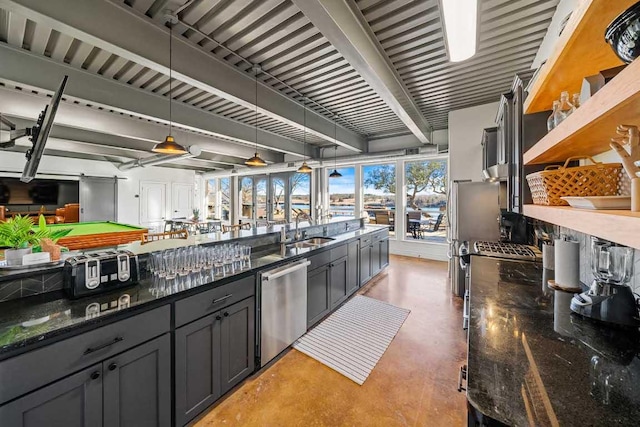 3500 River Oaks Dr, Kingsland, TX 78639 - kitchen featuring stainless steel dishwasher, finished concrete flooring, decorative light fixtures, dark stone counters, and open floor plan