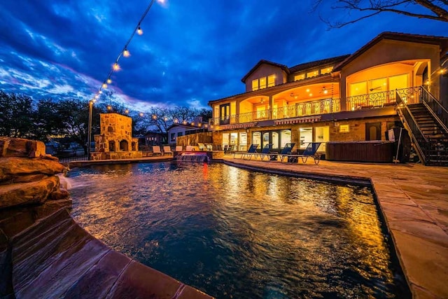 3500 River Oaks Dr, Kingsland, TX 78639 - swimming pool with a patio area, an outdoor stone fireplace, stairway, and a jacuzzi