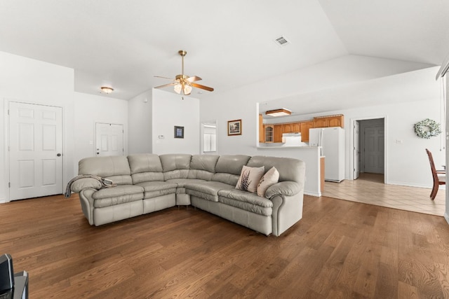 living area with vaulted ceiling, ceiling fan, and wood finished floors