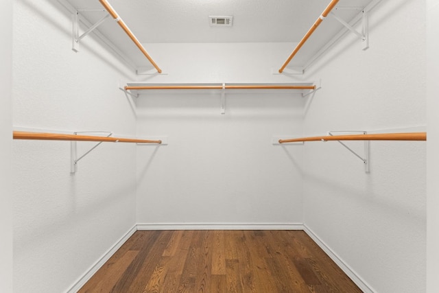 walk in closet featuring wood finished floors