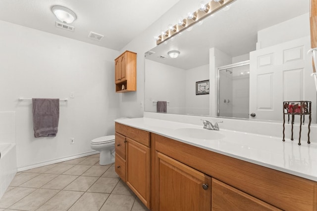 bathroom featuring a stall shower, tile patterned floors, toilet, vanity, and a bathtub