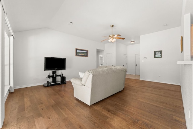 living room featuring ceiling fan, wood finished floors, baseboards, and lofted ceiling