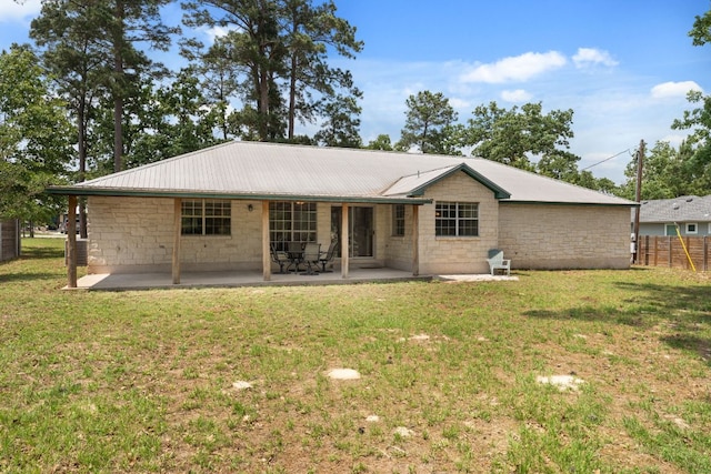 back of property with a patio area and metal roof