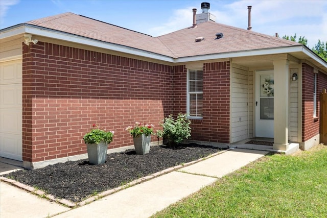 21223 Byerly Turk Dr, Pflugerville, TX 78660 - view of front of property featuring a garage, brick siding, and roof with shingles