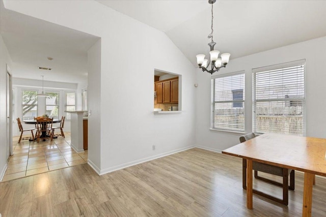 21223 Byerly Turk Dr, Pflugerville, TX 78660 - unfurnished dining area featuring a chandelier, light wood-style floors, baseboards, and vaulted ceiling