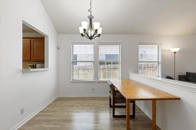 21223 Byerly Turk Dr, Pflugerville, TX 78660 - dining space featuring a chandelier, light wood-style flooring, and baseboards