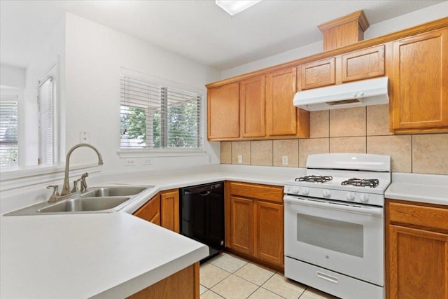21223 Byerly Turk Dr, Pflugerville, TX 78660 - kitchen featuring white gas range, under cabinet range hood, dishwasher, a sink, and light countertops