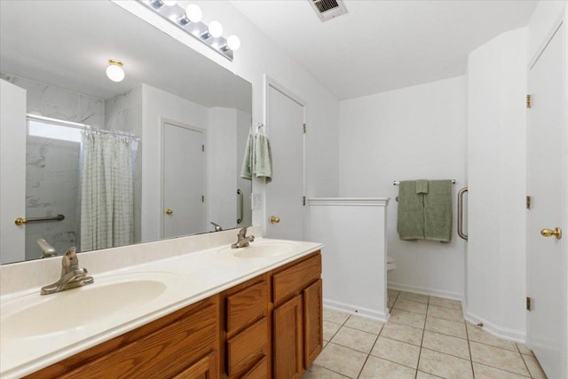 21223 Byerly Turk Dr, Pflugerville, TX 78660 - bathroom featuring toilet, double vanity, tile patterned floors, a shower with curtain, and baseboards