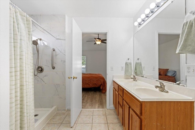 21223 Byerly Turk Dr, Pflugerville, TX 78660 - full bath featuring connected bathroom, double vanity, tiled shower, ceiling fan, and tile patterned flooring