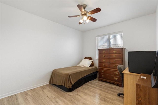 21223 Byerly Turk Dr, Pflugerville, TX 78660 - bedroom with light wood-style floors, a desk, baseboards, and a ceiling fan