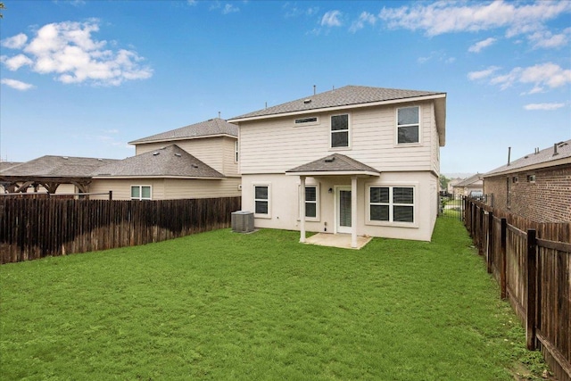 rear view of house featuring roof with shingles, stucco siding, a patio, and central AC