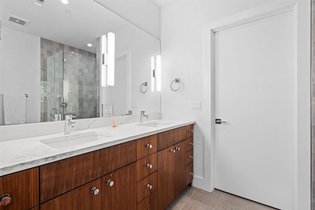 bathroom featuring a shower stall, double vanity, and recessed lighting