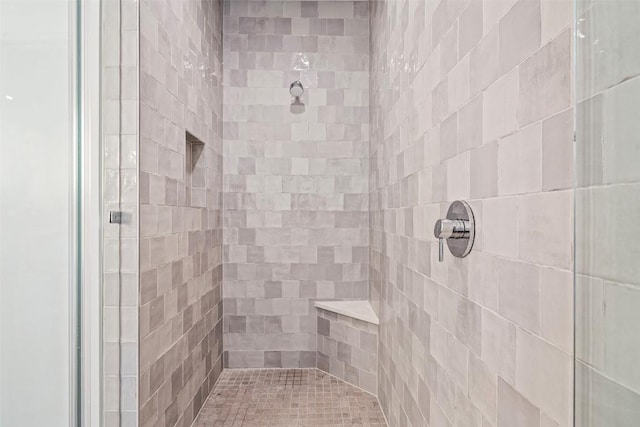 bathroom with tiled shower