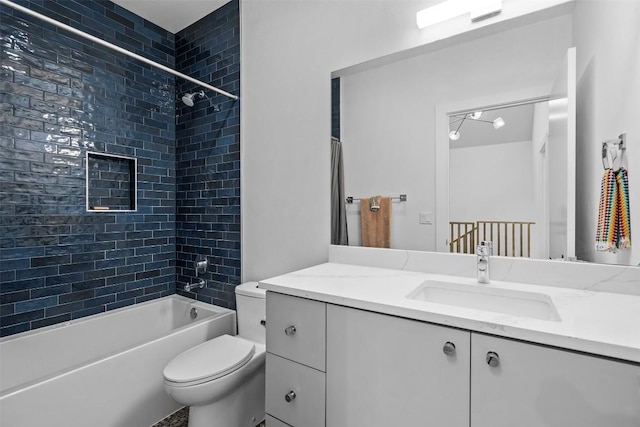 bathroom with toilet, vanity, and  shower combination