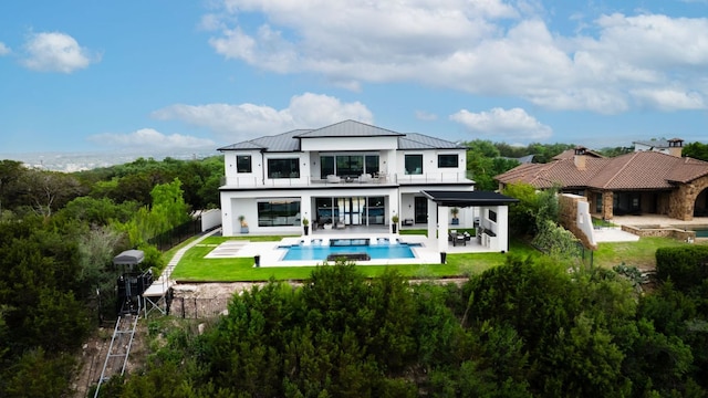 912 Watercliffe, Lago Vista, TX 78645 - rear view of property featuring a balcony, a standing seam roof, a patio area, and an outdoor pool