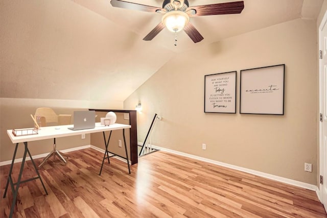 office area featuring wood finished floors, vaulted ceiling, baseboards, and a ceiling fan