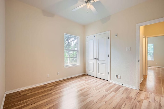 258 W Oak Loop, Cedar Creek, TX 78612 - unfurnished bedroom with light wood-style floors, baseboards, ceiling fan, and a closet