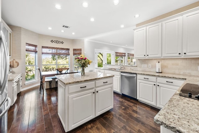 8909 Gallant Fox Rd, Austin, TX 78737 - kitchen with dishwasher, a sink, a kitchen island, ornamental molding, and dark wood-style flooring