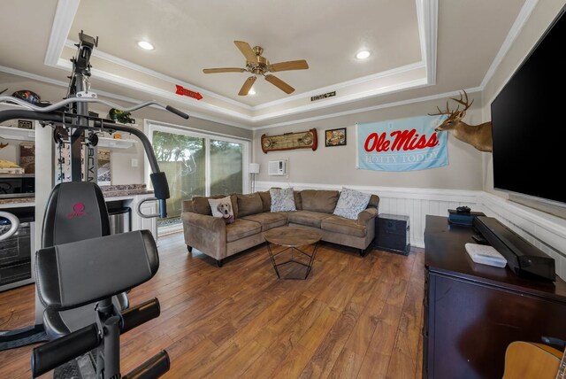 8909 Gallant Fox Rd, Austin, TX 78737 - living area with a tray ceiling, crown molding, a wainscoted wall, a ceiling fan, and hardwood / wood-style floors