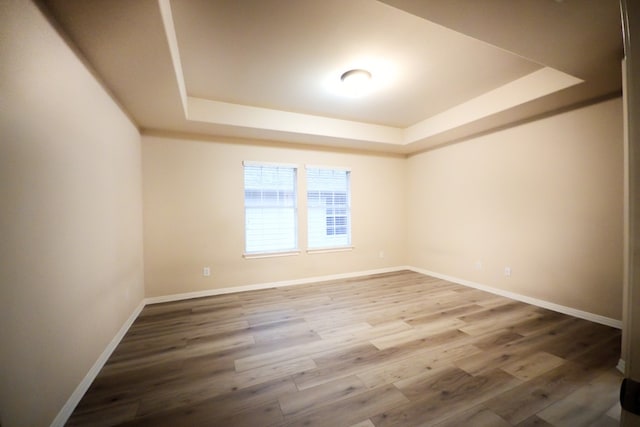 2702 Quiet Moon Trl, Cedar Park, TX 78613 - spare room featuring a raised ceiling and wood finished floors