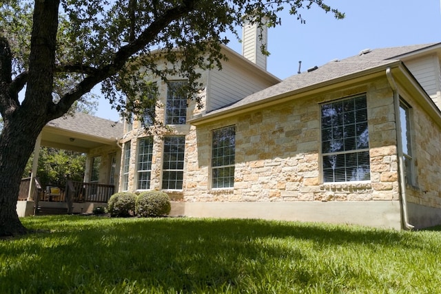 2702 Quiet Moon Trl, Cedar Park, TX 78613 - view of home's exterior with stone siding, a lawn, and a chimney