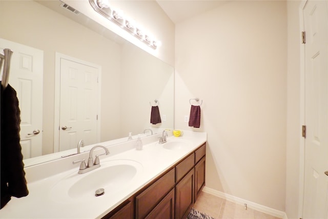 full bathroom featuring double vanity, tile patterned flooring, and baseboards