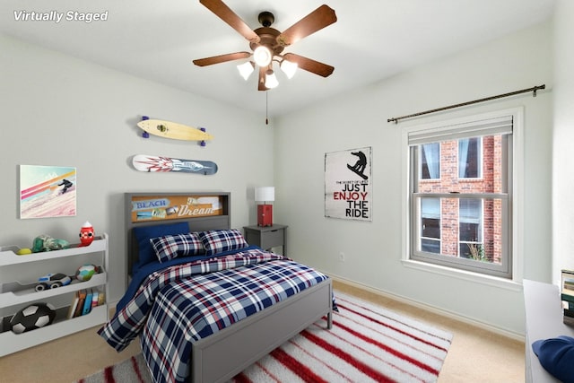 bedroom with carpet floors, a ceiling fan, and baseboards