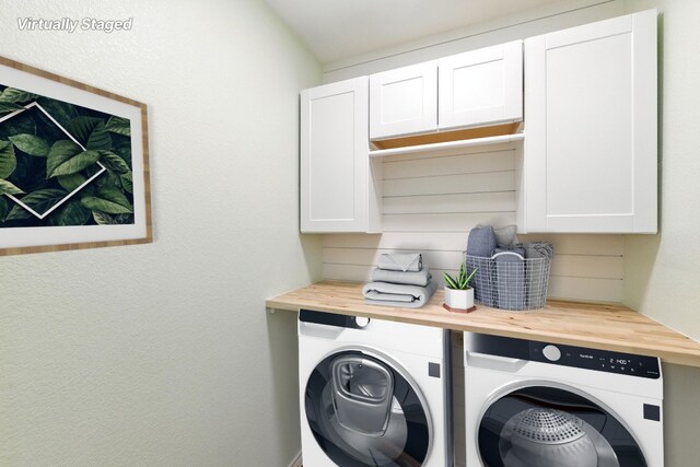 washroom featuring separate washer and dryer and cabinet space