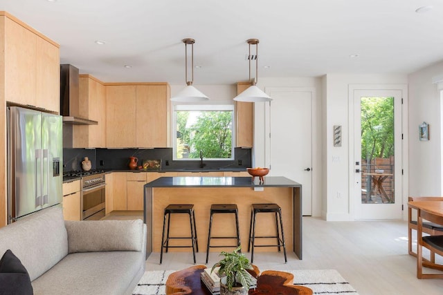 2305 E 17th St Unit B, Austin, TX 78702 - kitchen featuring light brown cabinetry, wall chimney range hood, a sink, healthy amount of natural light, and recessed lighting