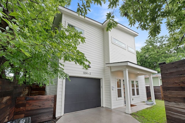 1204 W 51st St Unit 2, Austin, TX 78756 - view of front of home with a garage, fence, and driveway