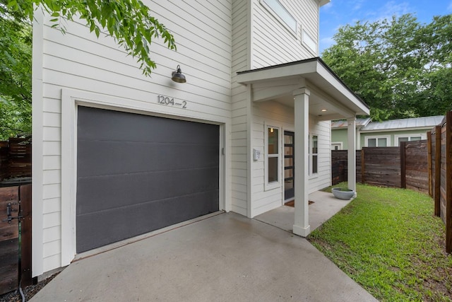 1204 W 51st St Unit 2, Austin, TX 78756 - garage with fence and concrete driveway