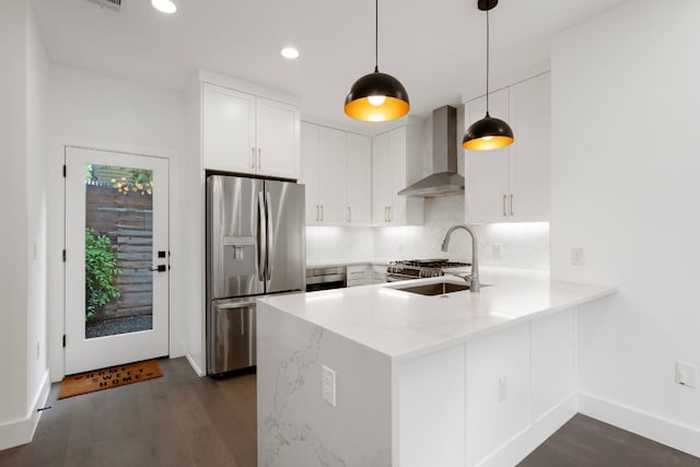 1204 W 51st St Unit 2, Austin, TX 78756 - kitchen with stainless steel fridge, wall chimney exhaust hood, a peninsula, dark wood finished floors, and recessed lighting