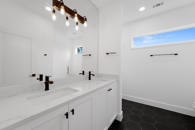1204 W 51st St Unit 2, Austin, TX 78756 - full bath with healthy amount of natural light, double vanity, tile patterned flooring, and baseboards